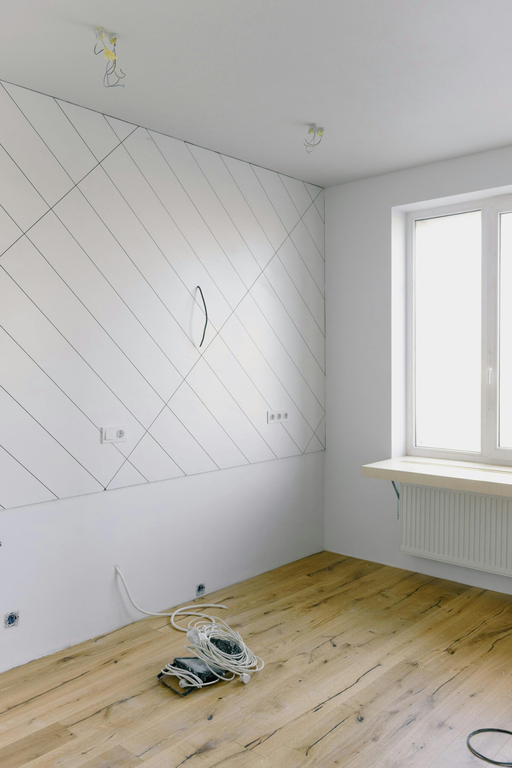 Electrical and installation work in light empty room with big window and new design